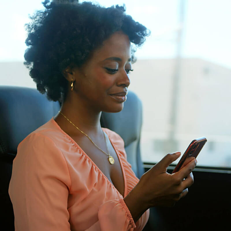 Woman using her phone on a bus